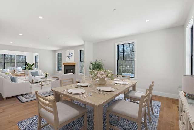 11 Acorn Ave, Kennebunkport, ME 04046 - dining space with light wood finished floors, recessed lighting, healthy amount of natural light, a fireplace, and baseboards