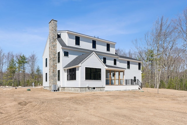 11 Acorn Ave, Kennebunkport, ME 04046 - rear view of house with central AC, a chimney, and roof with shingles