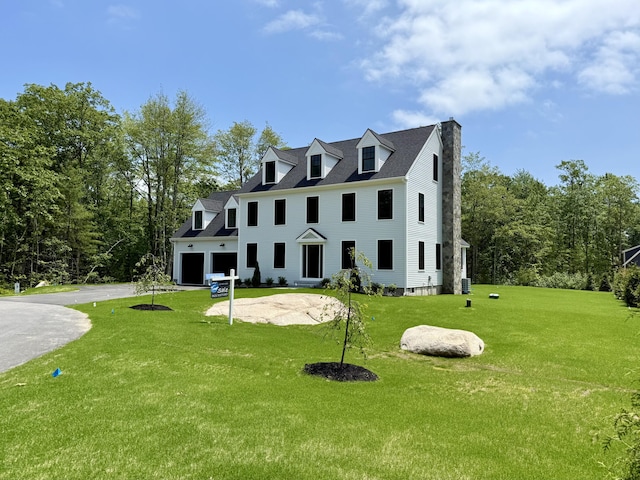 11 Acorn Ave, Kennebunkport, ME 04046 - view of front of home with driveway, a front lawn, a chimney, and a garage