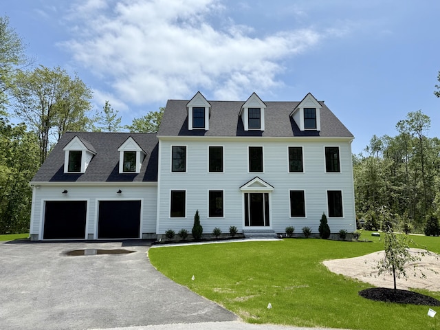 11 Acorn Ave, Kennebunkport, ME 04046 - view of front of house featuring asphalt driveway, entry steps, a front yard, and an attached garage