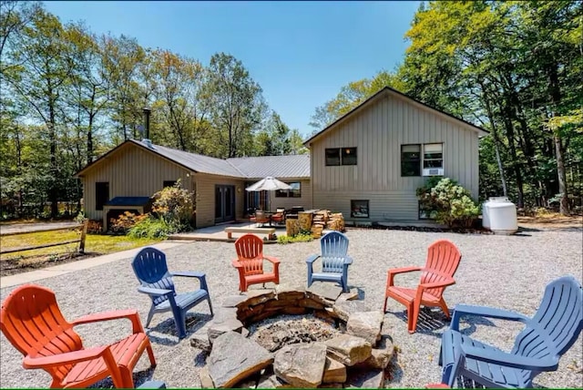 597 Sweden Rd, Bridgton, ME 04009 - back of house featuring a fire pit, board and batten siding, and a patio
