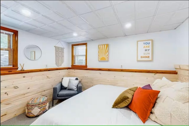597 Sweden Rd, Bridgton, ME 04009 - bedroom featuring wooden walls, multiple windows, and a wainscoted wall