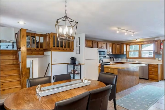 597 Sweden Rd, Bridgton, ME 04009 - kitchen featuring stainless steel appliances, brown cabinets, a center island, light countertops, and a chandelier