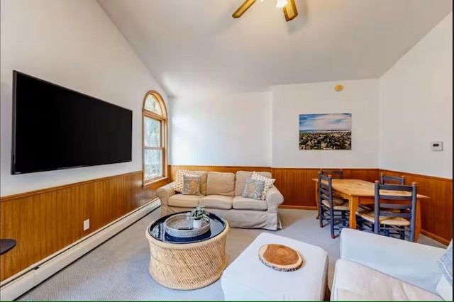 597 Sweden Rd, Bridgton, ME 04009 - living room with a baseboard radiator, wainscoting, carpet floors, wood walls, and a ceiling fan