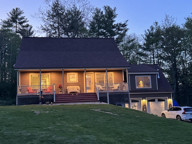 view of front facade with a front lawn, a porch, and a garage