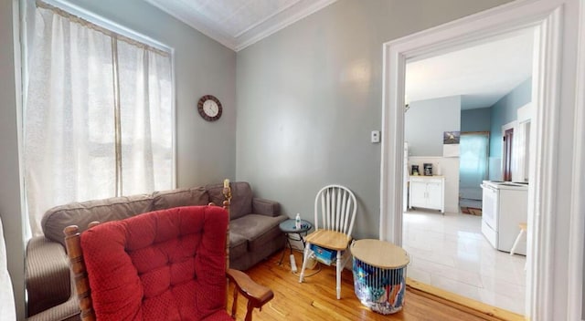 living area featuring crown molding