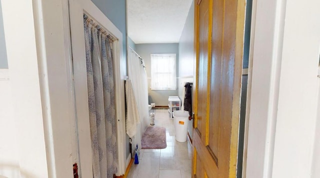 corridor with light tile patterned floors