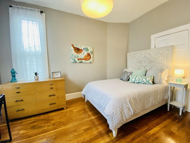 bedroom with wood finished floors and baseboards