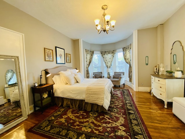 bedroom featuring a chandelier, dark wood-style floors, access to outside, and baseboards