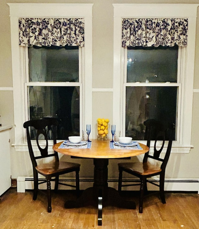 dining space with wood finished floors