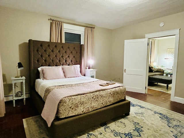 bedroom with dark wood-style flooring