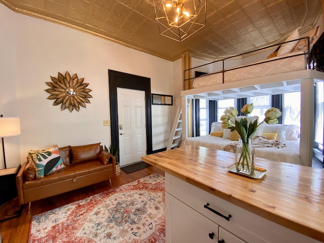 living room featuring an ornate ceiling, wood finished floors, and a chandelier