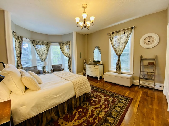 bedroom featuring a chandelier, wood finished floors, a baseboard radiator, and baseboards