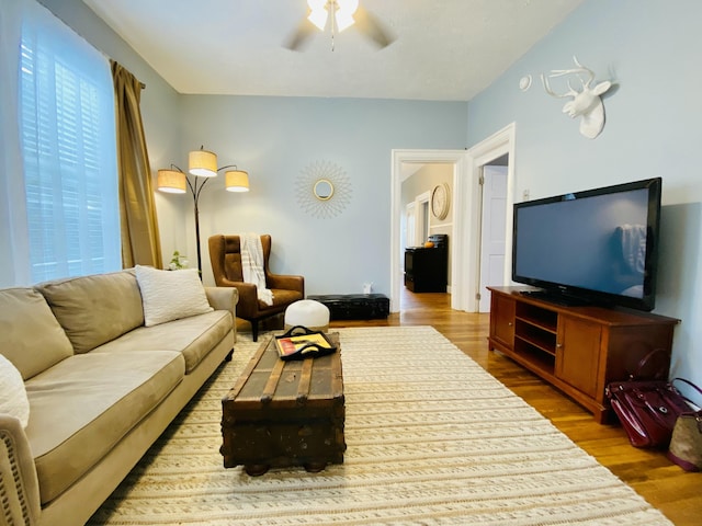 living area with ceiling fan and wood finished floors