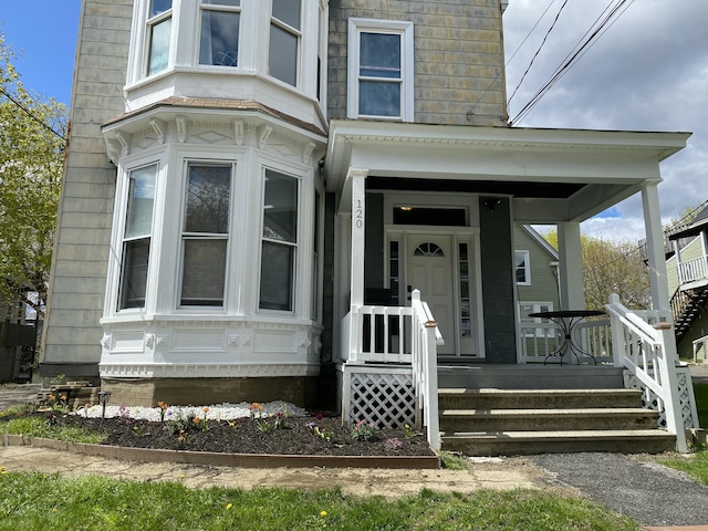 doorway to property featuring covered porch