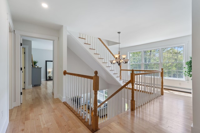 11 Oxford Rd, Windham, ME 04062 - stairway with baseboard heating, a chandelier, hardwood / wood-style flooring, baseboards, and recessed lighting