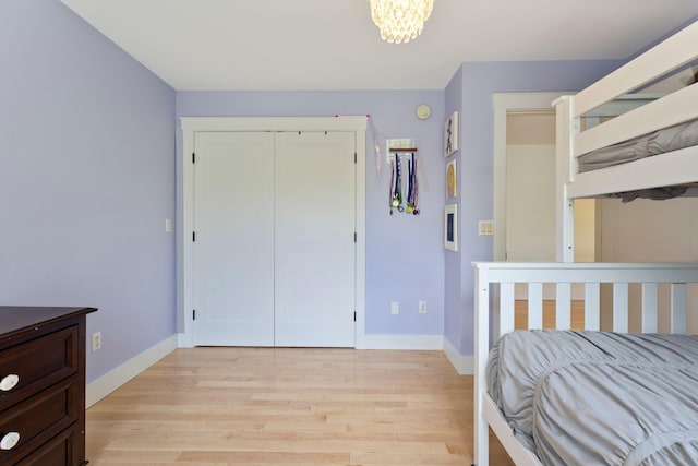 11 Oxford Rd, Windham, ME 04062 - bedroom with light wood-style floors, baseboards, a chandelier, and a closet