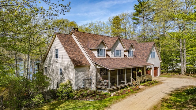1 Mayflower Way, Norway, ME 04268 - view of front facade with a chimney, a garage, roof with shingles, driveway, and a porch