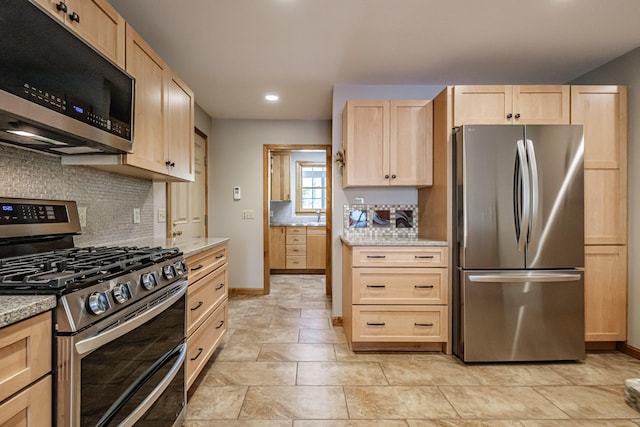 1 Mayflower Way, Norway, ME 04268 - kitchen featuring stainless steel appliances, light brown cabinets, tasteful backsplash, recessed lighting, and light stone counters
