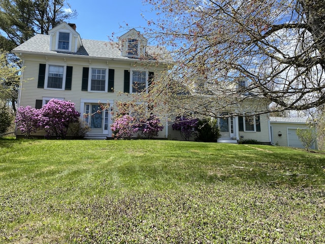 12 Old Rte 1, Searsport, ME 04974 - view of front of house with a front yard, a shingled roof, a chimney, and entry steps