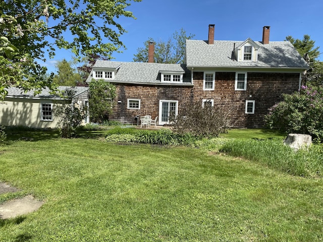 12 Old Rte 1, Searsport, ME 04974 - back of house featuring a chimney, a yard, a shingled roof, and a patio area
