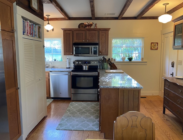 12 Old Rte 1, Searsport, ME 04974 - kitchen featuring stainless steel appliances, light wood finished floors, beamed ceiling, and plenty of natural light