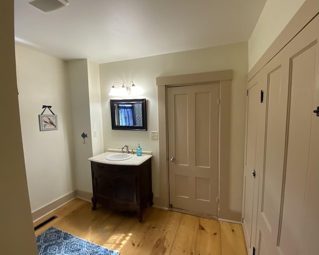 12 Old Rte 1, Searsport, ME 04974 - bathroom with wood finished floors, vanity, and baseboards