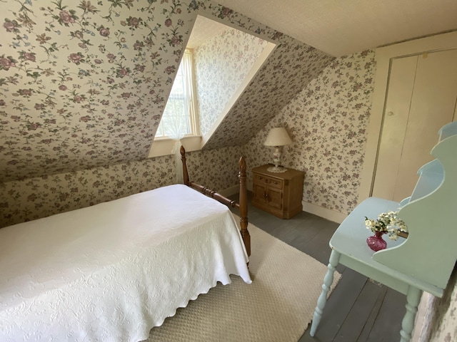 12 Old Rte 1, Searsport, ME 04974 - bedroom featuring wallpapered walls, wood finished floors, baseboards, and lofted ceiling