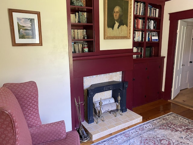 12 Old Rte 1, Searsport, ME 04974 - living area featuring wood finished floors, a tiled fireplace, and built in features