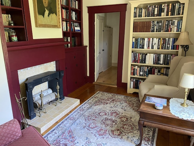 12 Old Rte 1, Searsport, ME 04974 - sitting room with wood finished floors, a tiled fireplace, and baseboards