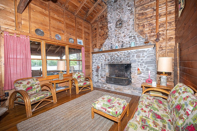 106 Shady Ln, Parsonsfield, ME 04047 - living area with wood walls, wooden ceiling with exposed beams, high vaulted ceiling, wood finished floors, and a fireplace