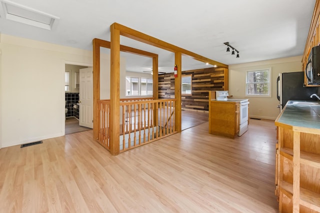 227 Forest Ave, Orono, ME 04473 - kitchen featuring white electric range, light wood finished floors, a sink, track lighting, and baseboards