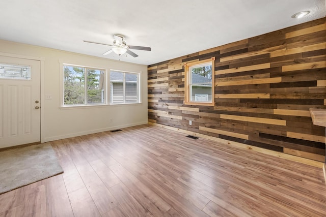227 Forest Ave, Orono, ME 04473 - foyer featuring plenty of natural light, ceiling fan, wooden walls, wood finished floors, and baseboards