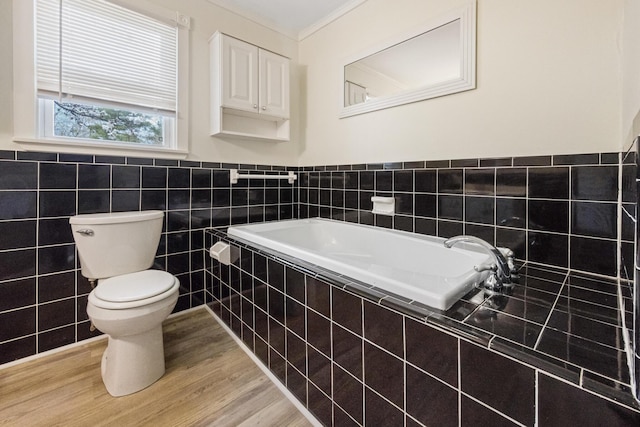 227 Forest Ave, Orono, ME 04473 - full bathroom featuring toilet, tile walls, a garden tub, wainscoting, and wood finished floors