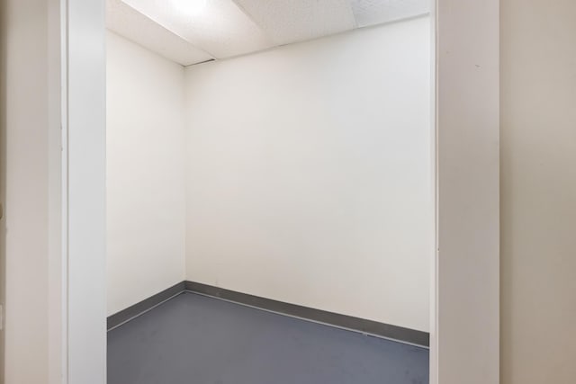 227 Forest Ave, Orono, ME 04473 - spare room featuring finished concrete floors, baseboards, and a drop ceiling