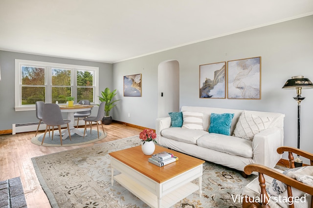 living area with baseboards, arched walkways, light wood-style floors, ornamental molding, and baseboard heating