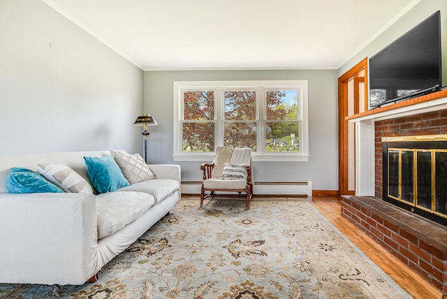 living room featuring a fireplace, crown molding, wood finished floors, baseboards, and a baseboard radiator