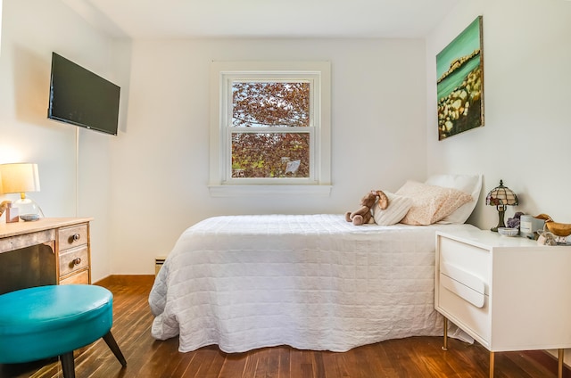 bedroom with dark wood finished floors