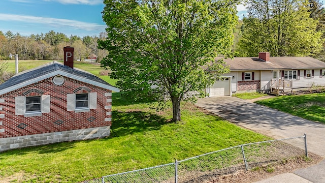 ranch-style home featuring a garage, a chimney, and driveway