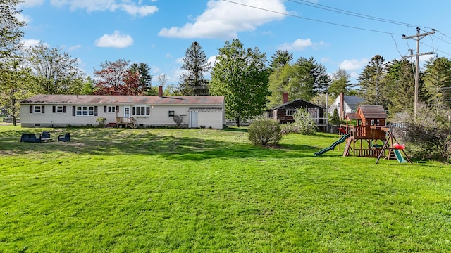 back of house with a playground and a lawn