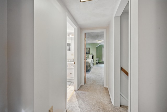 hallway featuring light carpet