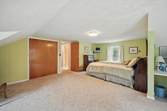 bedroom with carpet flooring and lofted ceiling
