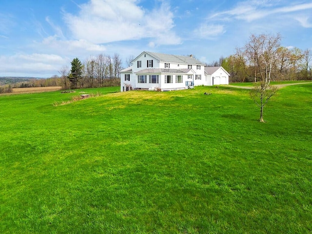 rear view of house featuring a yard