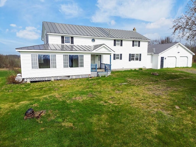 view of front of home with a standing seam roof, a porch, a front yard, and metal roof