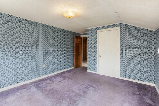 bonus room featuring wallpapered walls, lofted ceiling, carpet floors, and baseboards