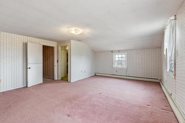 bonus room with wallpapered walls, a baseboard heating unit, carpet floors, and baseboard heating