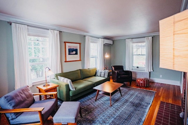 living room featuring a wall unit AC, wood finished floors, crown molding, healthy amount of natural light, and baseboards