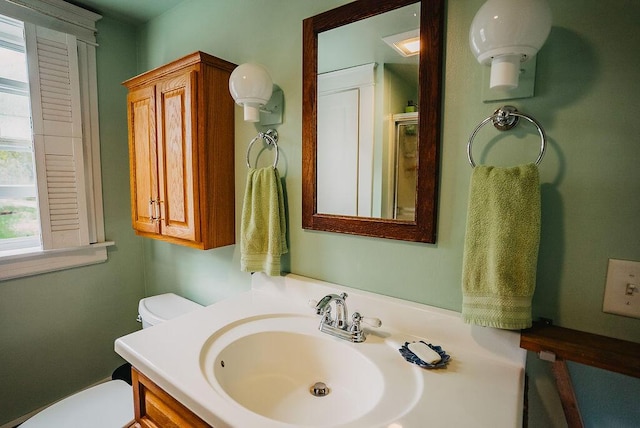 bathroom with toilet and vanity