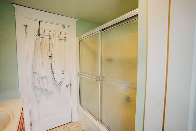 bathroom with bath / shower combo with glass door and vanity