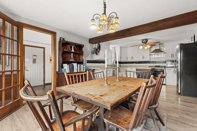 28 Ridgewood Dr, Eliot, ME 03903 - dining space with light wood finished floors, a ceiling fan, a chandelier, and beam ceiling